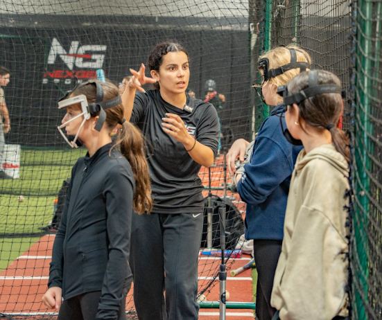 Coach instructing players during a clinic