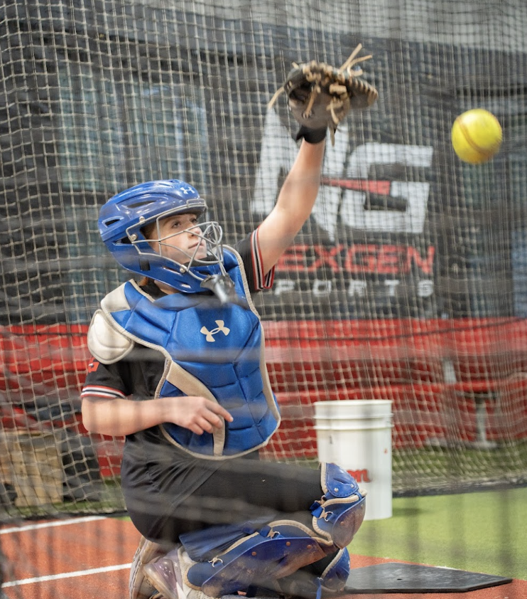 NexGen catcher framing a softball during a private lesson