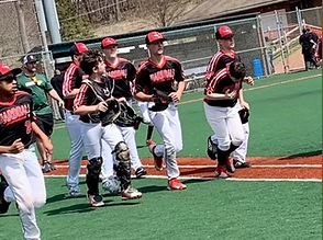 NexGen travel baseball team running onto the field