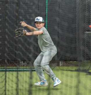 NexGen athlete fielding in the indoor cages